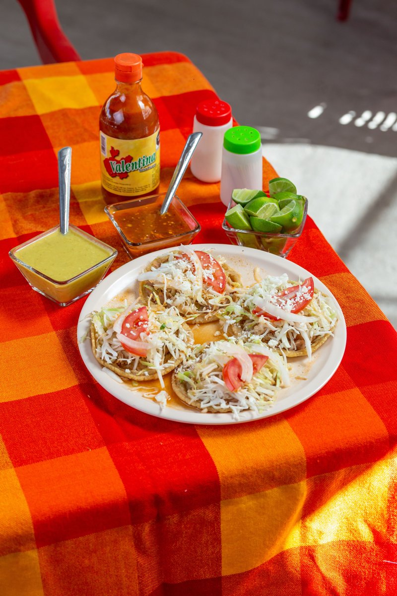 Soft tacos topped with cheese and lettuce